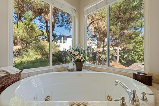 a bathroom with a granite countertop toilet a sink and a mirror