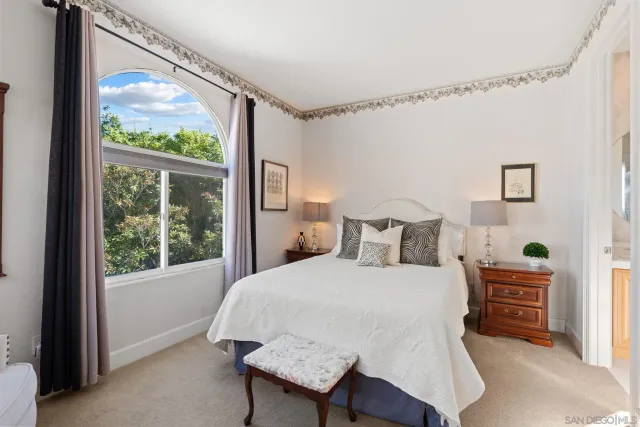 a living room with furniture a flat screen tv and a window