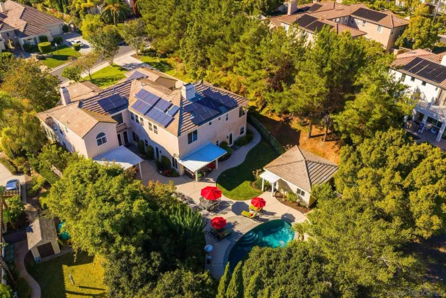 an aerial view of a house with a yard and swimming pool