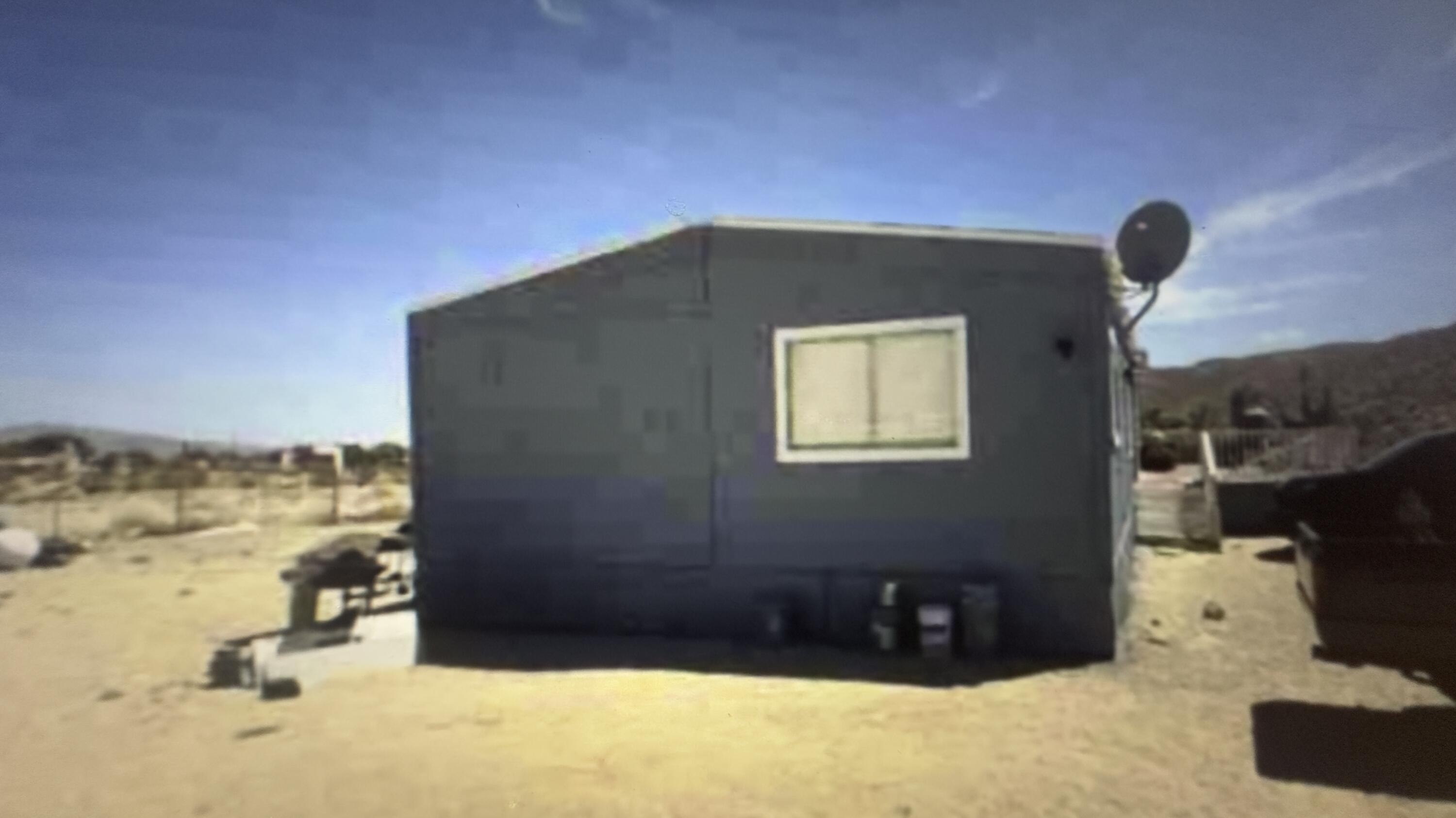 Undisclosed Address Desert Hot Springs, CA 92241 - Photo 17 of 29 a front view of a house with a yard
