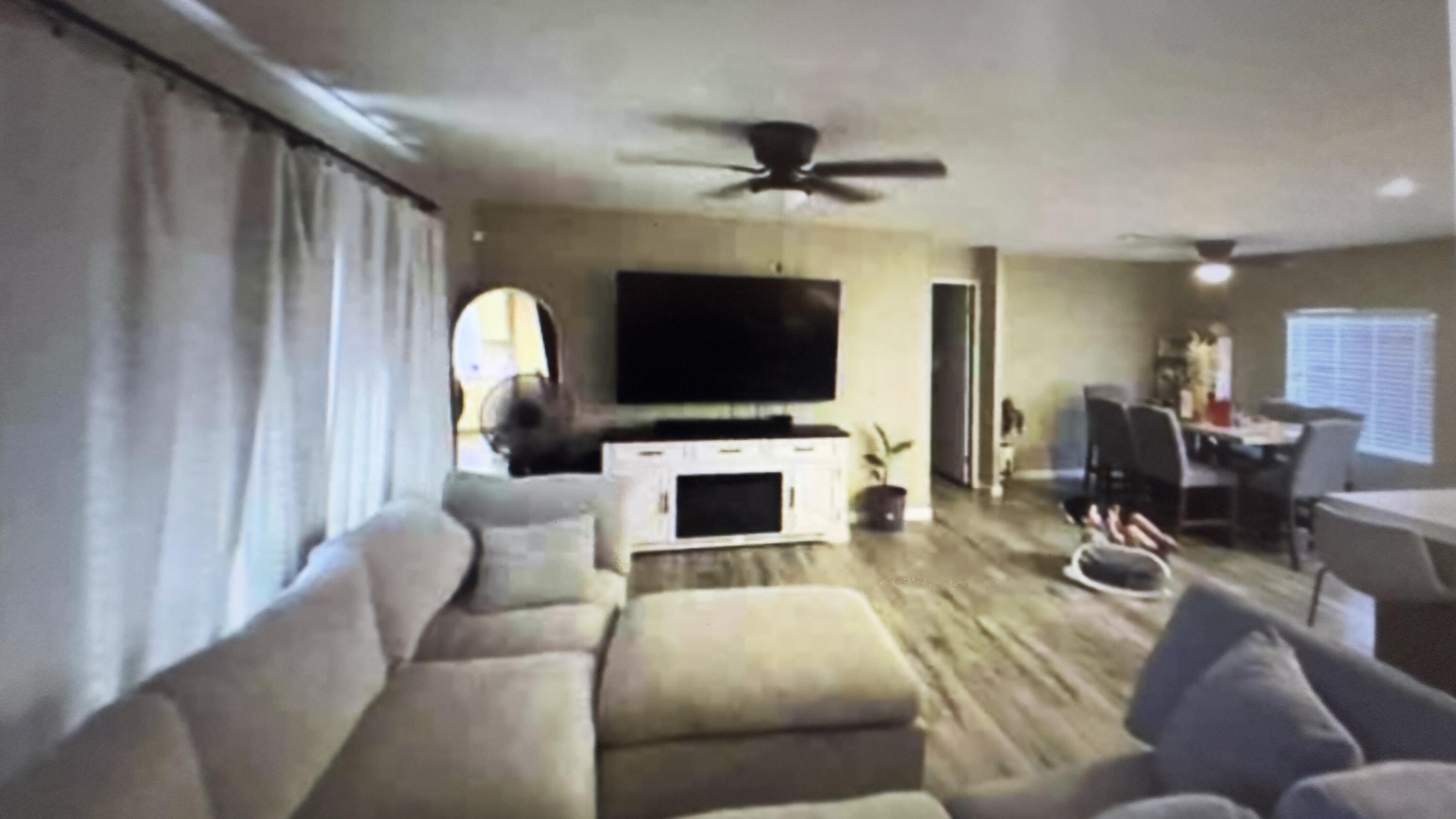 Undisclosed Address Desert Hot Springs, CA 92241 - Photo 20 of 29 a living room with furniture a flat screen tv and a fireplace