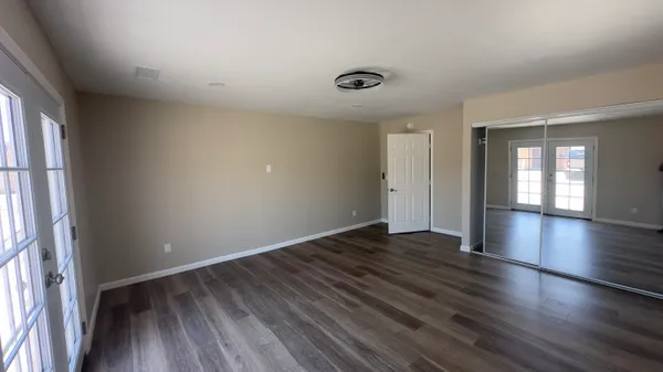 a utility room with cabinets and wooden floor