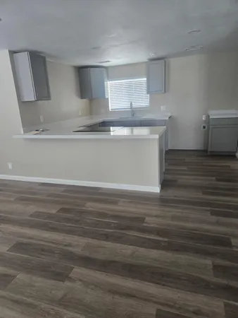a view of a hallway with livingroom and furniture