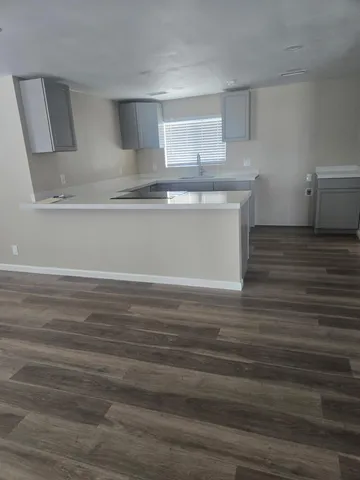 a view of a hallway with livingroom and furniture