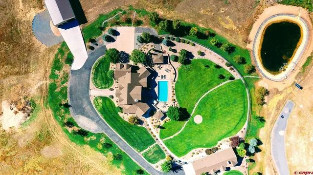 an aerial view of a residential houses with yard