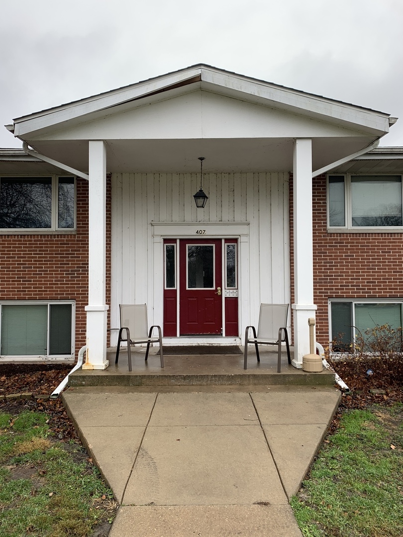 407 East Seminole Street, Unit 5 Dwight, IL 60420 - Photo 1 of 1 a front view of a house with a yard