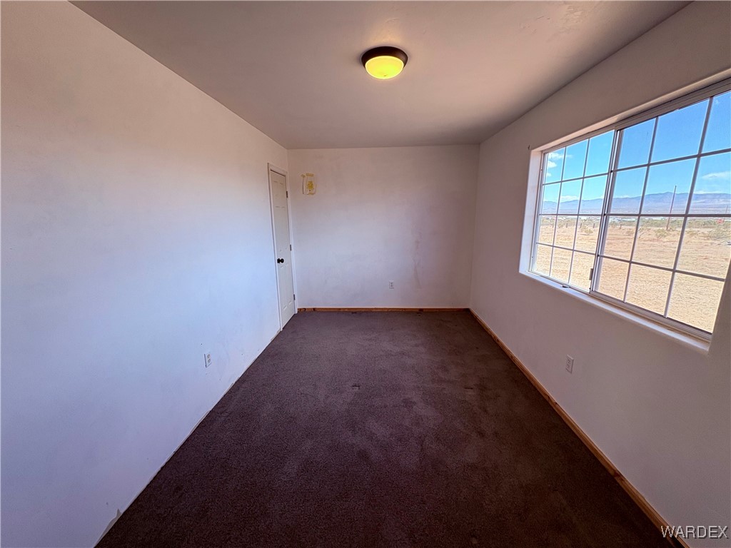 1757 Glenbar Road Golden Valley, AZ 86413 - Photo 21 of 33 Unfurnished room featuring baseboards and carpet