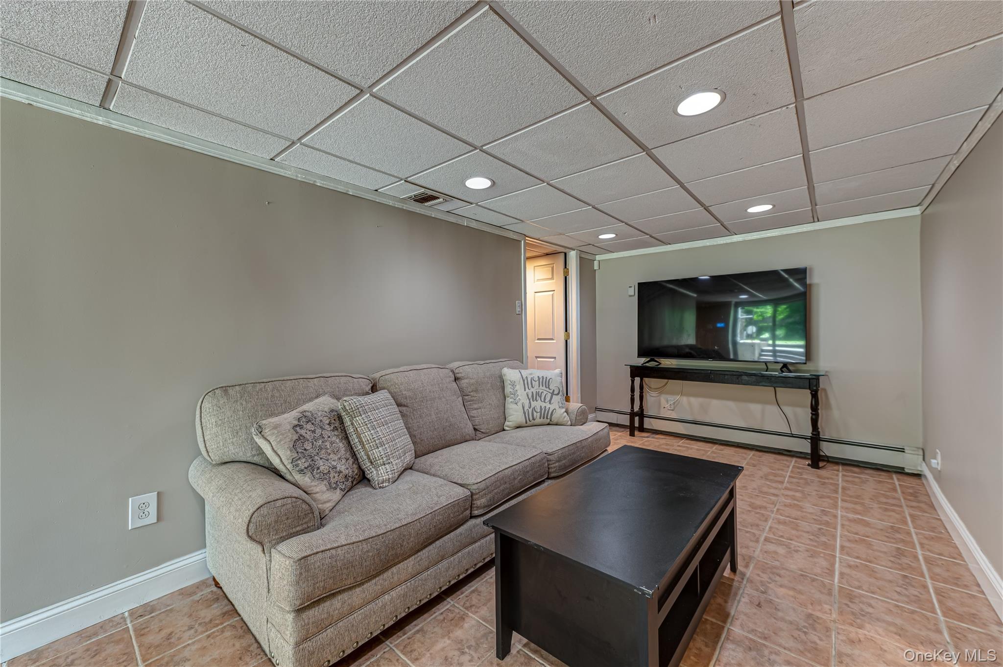 3 Thompson Hill Road St. James, NY 11780 - Photo 23 of 34 a living room with furniture and a flat screen tv