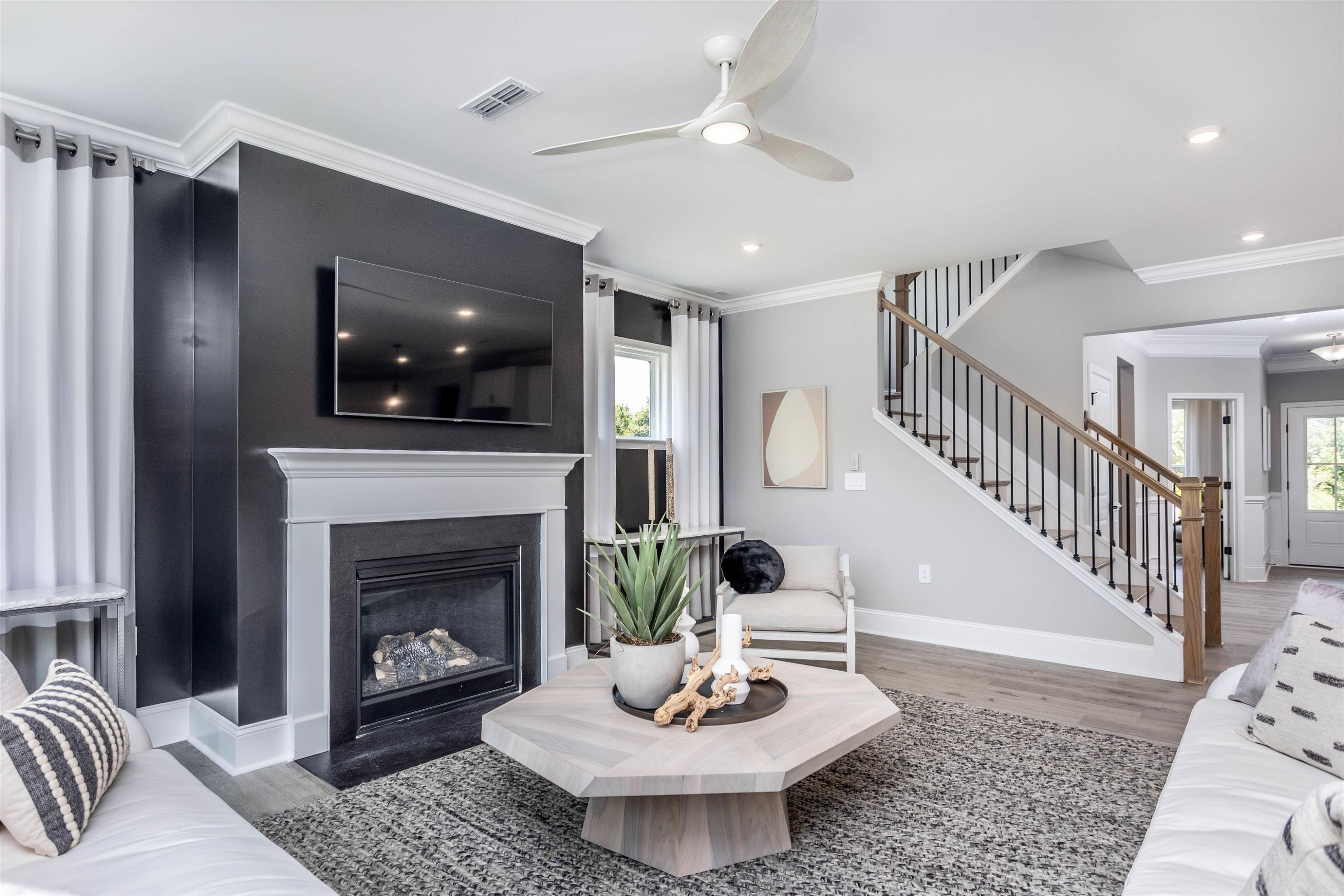 300 Heritage Regency Drive Wake Forest, NC 27587 - Photo 4 of 31 a living room with furniture a flat screen tv and a fireplace