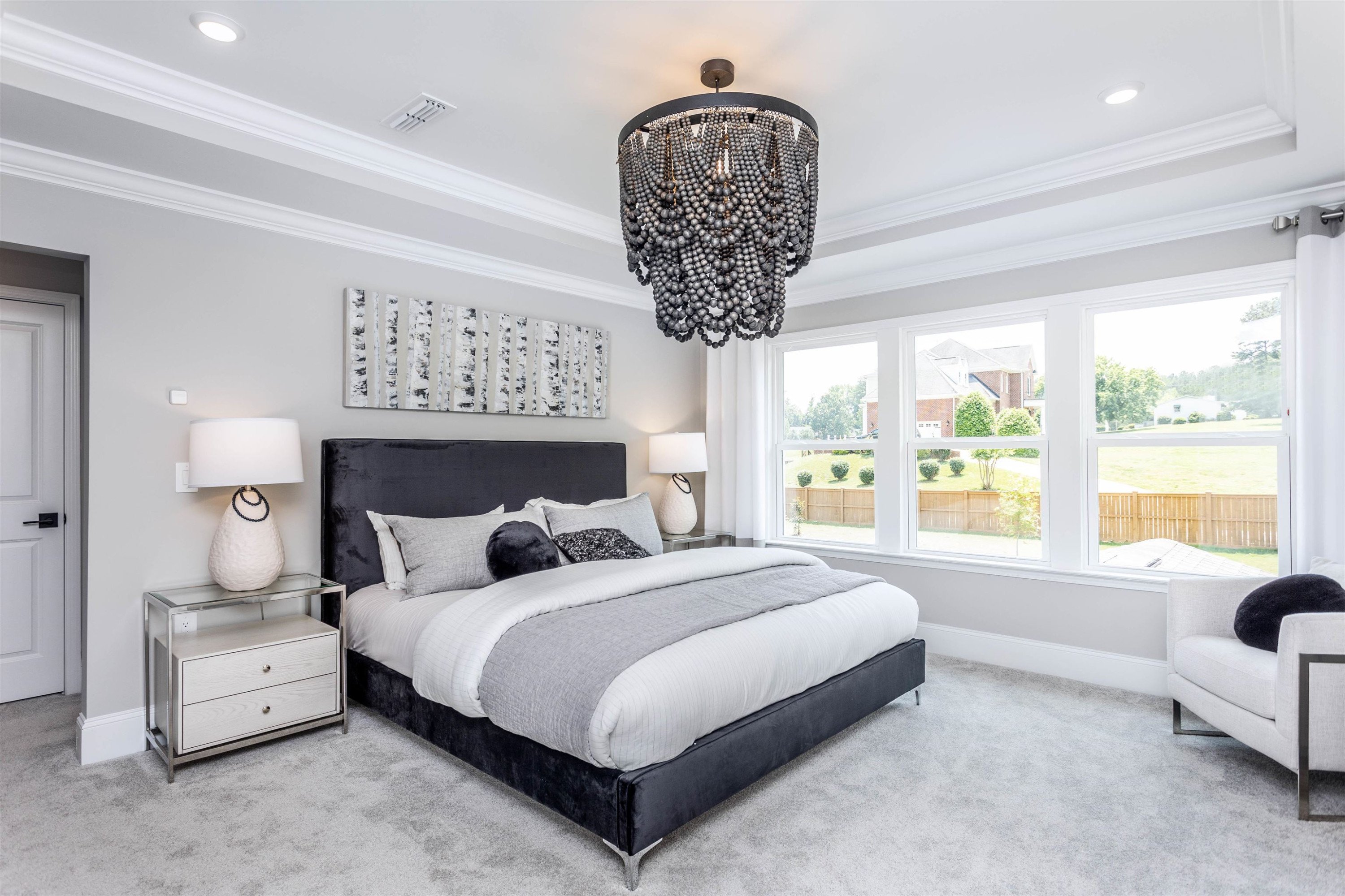 300 Heritage Regency Drive Wake Forest, NC 27587 - Photo 8 of 31 a bedroom with a large bed and a chandelier