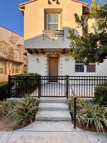 a front view of a house with a bench