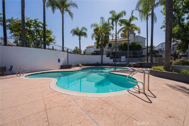 a view of a white house with a fountain and a fountain