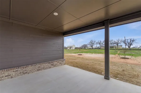 a view of a floor to ceiling window and wooden fence