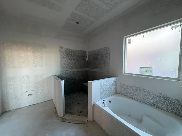 a bathroom with a bathtub sink and window