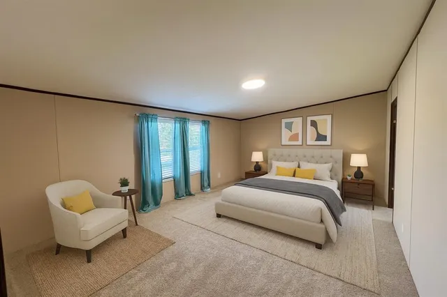 a spacious bedroom with a bed and a large window