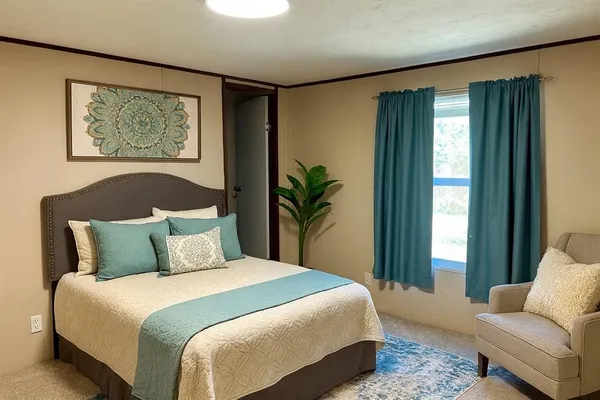 a bedroom with a large bed and a window