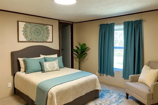 a bedroom with a large bed and a window