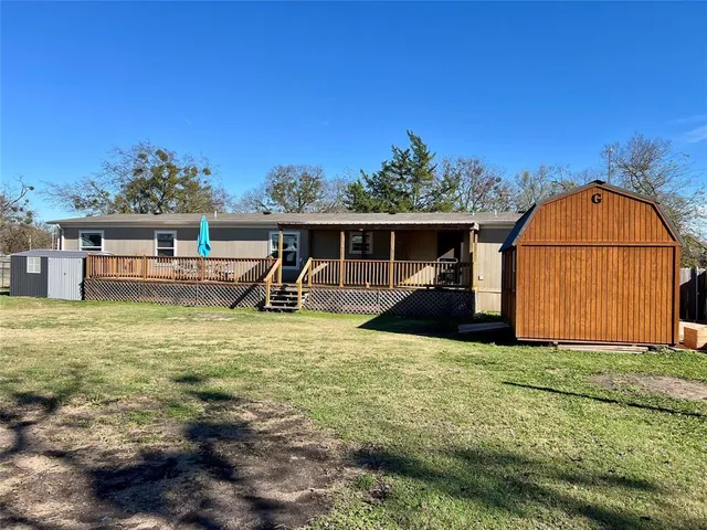 a view of a house with backyard porch and furniture