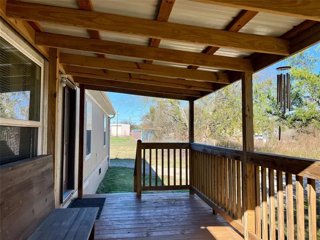 a view of a porch with wooden floor