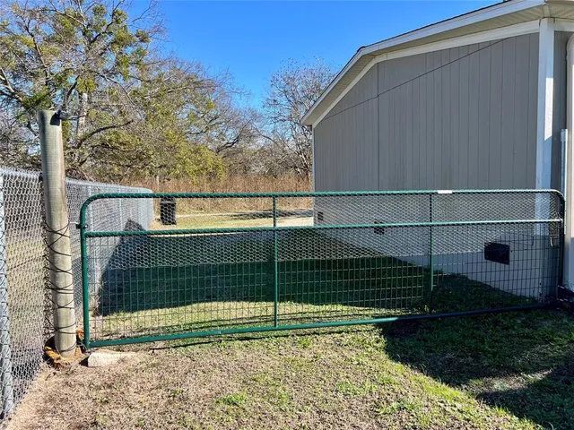 a view of a backyard with a fence