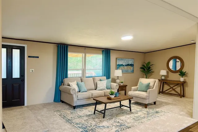 a living room with furniture and a floor to ceiling window