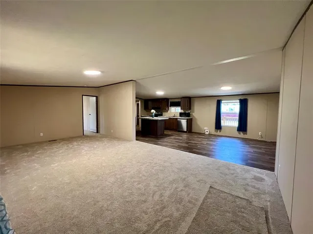 a view of a livingroom with furniture wooden floor and window