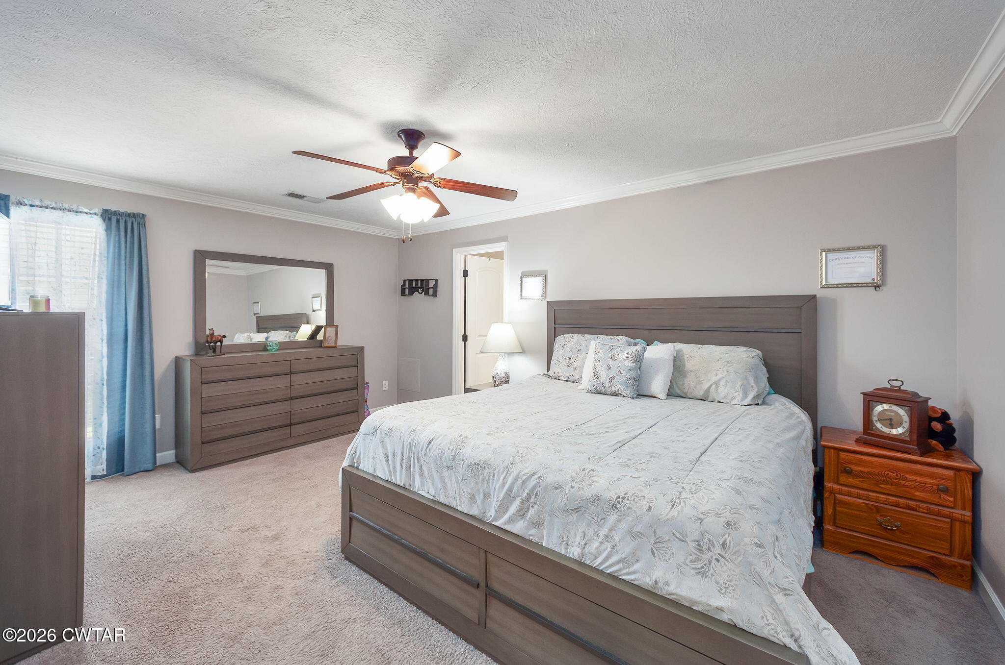 255 Taylor Drive Bells, TN 38006 - Photo 11 of 28 a bedroom with a bed and a chandelier