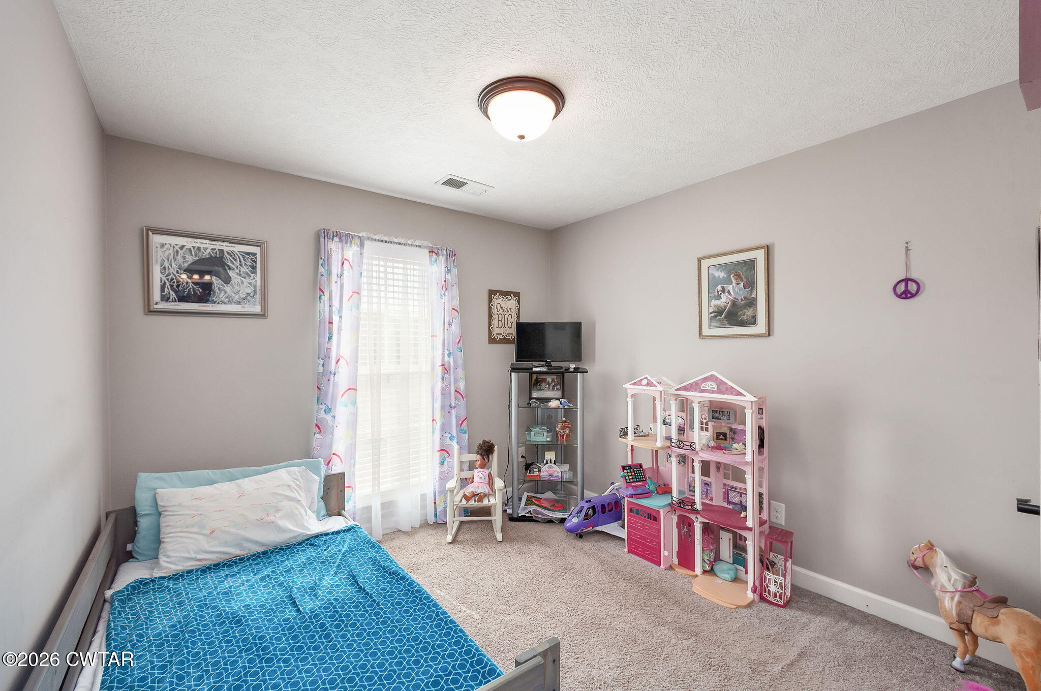255 Taylor Drive Bells, TN 38006 - Photo 21 of 28 a bedroom with furniture and a chandelier