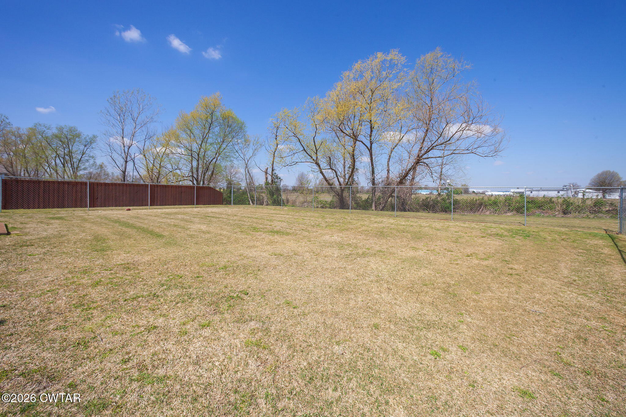 255 Taylor Drive Bells, TN 38006 - Photo 24 of 28 a view of a yard with a house in the background