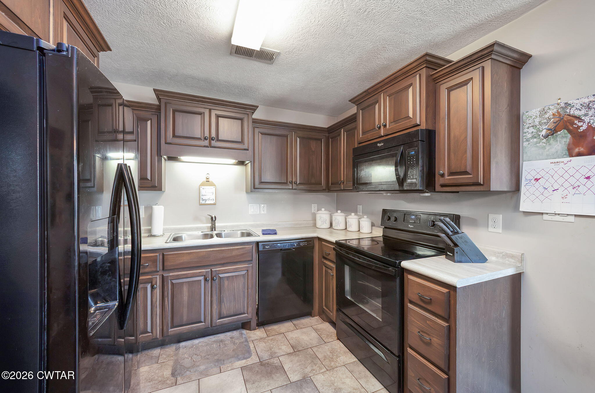 255 Taylor Drive Bells, TN 38006 - Photo 5 of 28 a kitchen with stainless steel appliances granite countertop a sink stove refrigerator and cabinets
