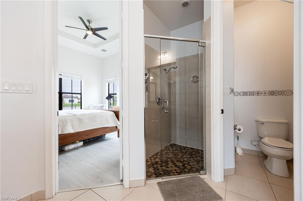 5116 Salerno Street Ave Maria, FL 34142 - Photo 21 of 36 Full bathroom with ensuite bath, a stall shower, light tile patterned floors, and ceiling fan
