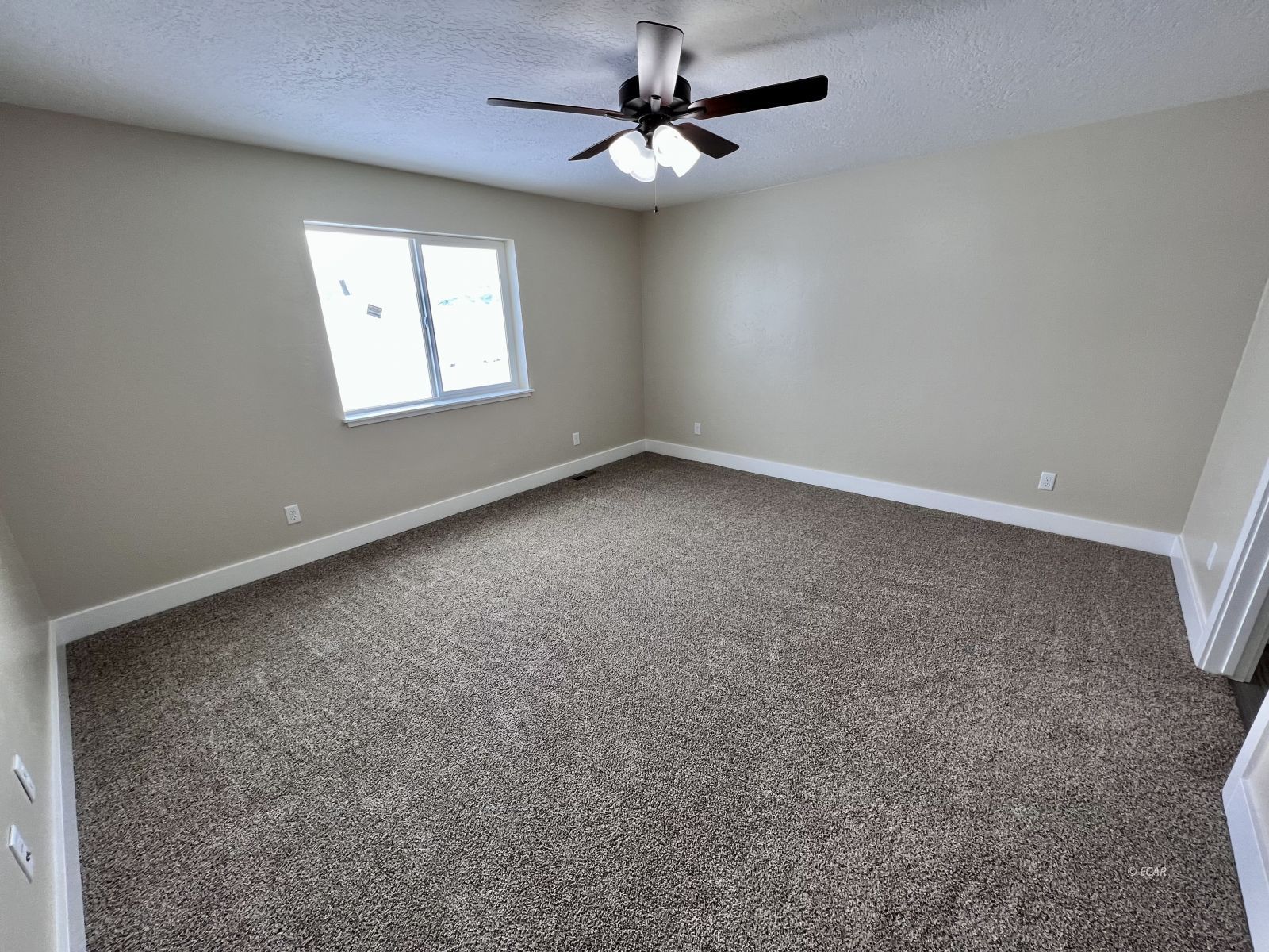997 Sun Vly Road Spring Creek, NV 89815 - Photo 9 of 27 an empty room with windows and fan
