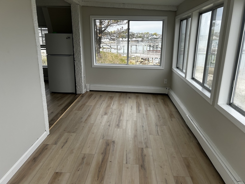 8 Beaver Dam Road, Unit B Scituate, MA 02066 - Photo 6 of 14 a view of a room with wooden floor and window