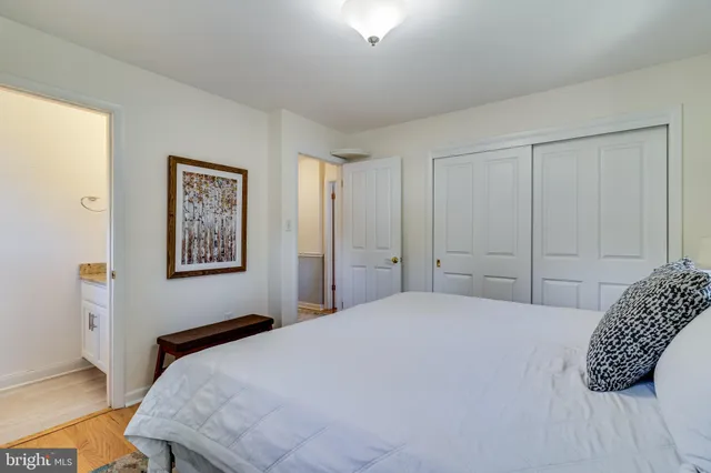 a bedroom with a bed and a painting on the wall