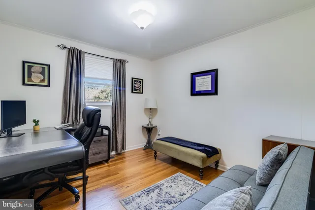 a bedroom with furniture and a desk