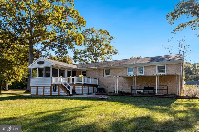 a front view of a house with swimming pool having outdoor seating