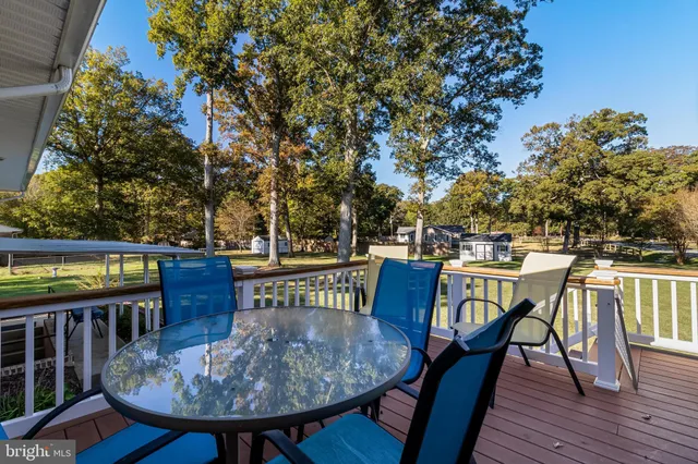 a view of a chairs and table on the deck