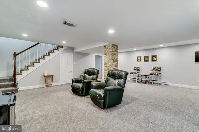 a living room with furniture and a dining table with projector the view