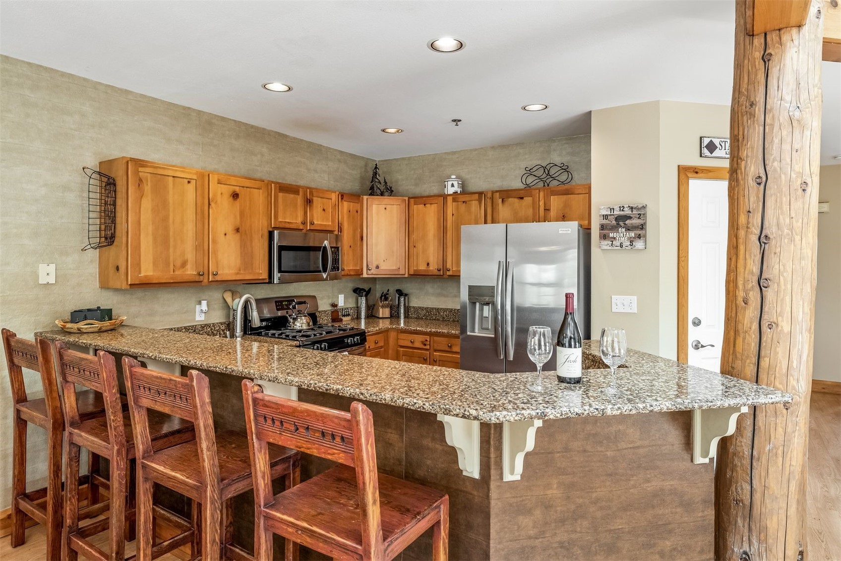 71 Starfire Lane, Unit 1978 Keystone, CO 80435 - Photo 6 of 40 a kitchen with stainless steel appliances granite countertop a stove a sink and a microwave