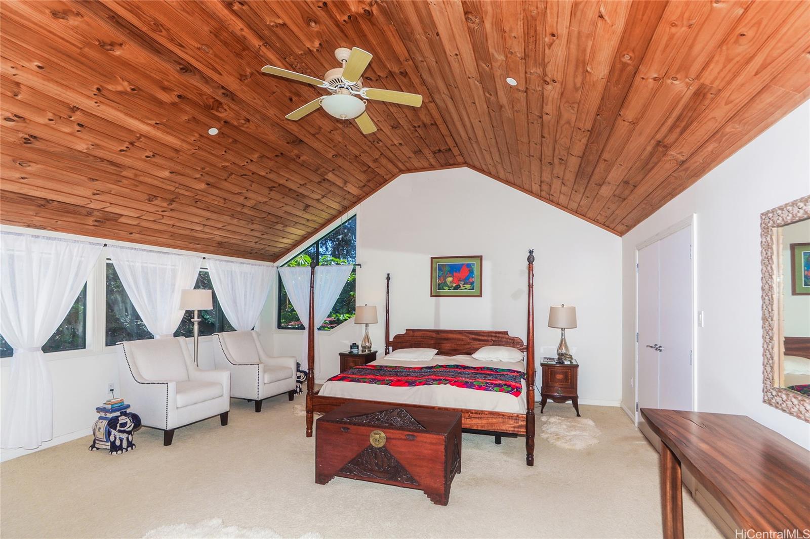 3702 Old Pali Road Honolulu, HI 96817 - Photo 7 of 25 a bedroom with a bed and a chandelier