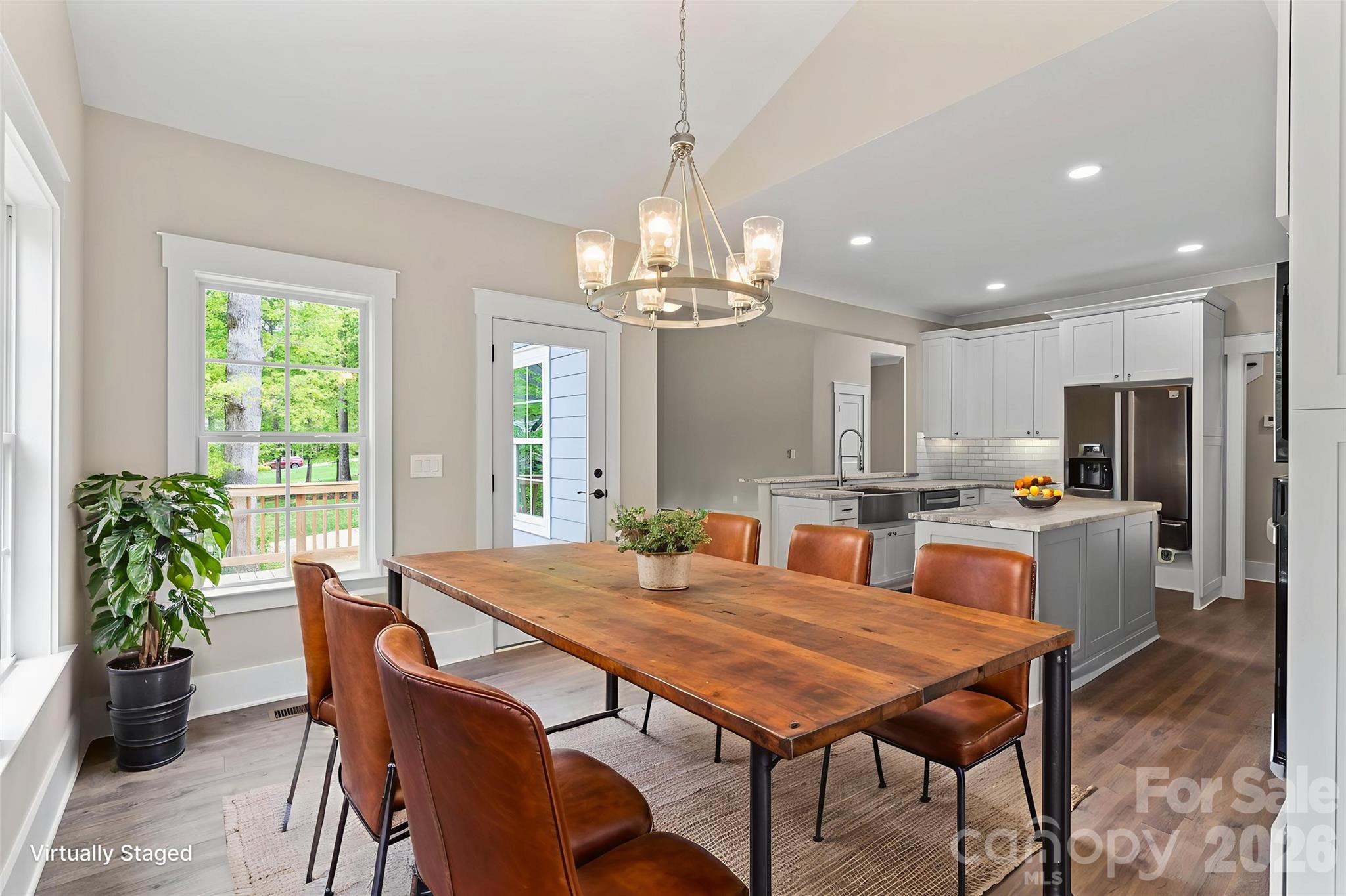 156 Clear Springs Road Mooresville, NC 28115 - Photo 11 of 28 a dining room with furniture a large window and chandelier