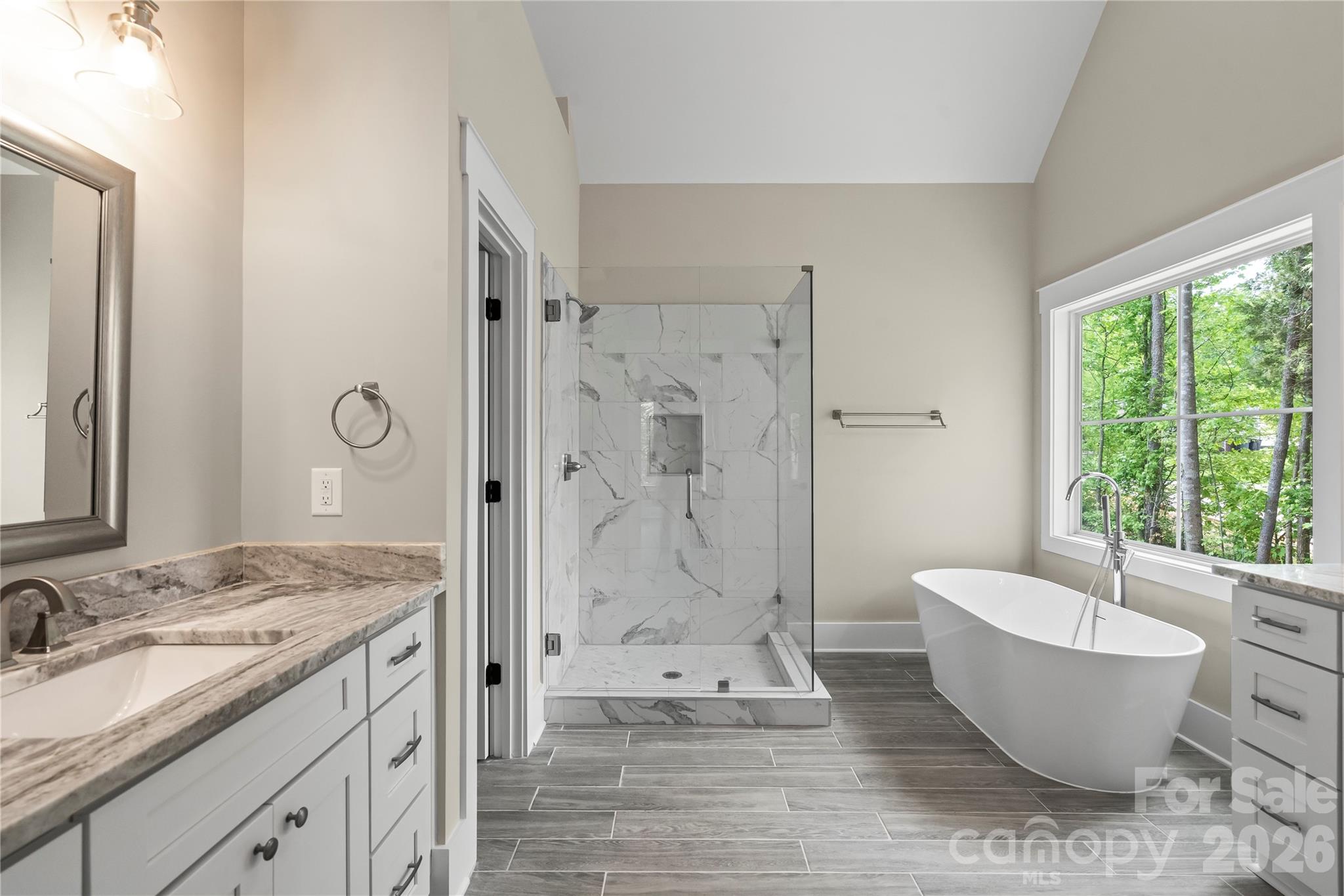 156 Clear Springs Road Mooresville, NC 28115 - Photo 14 of 28 a spacious bathroom with a granite countertop tub sink a shower and a mirror