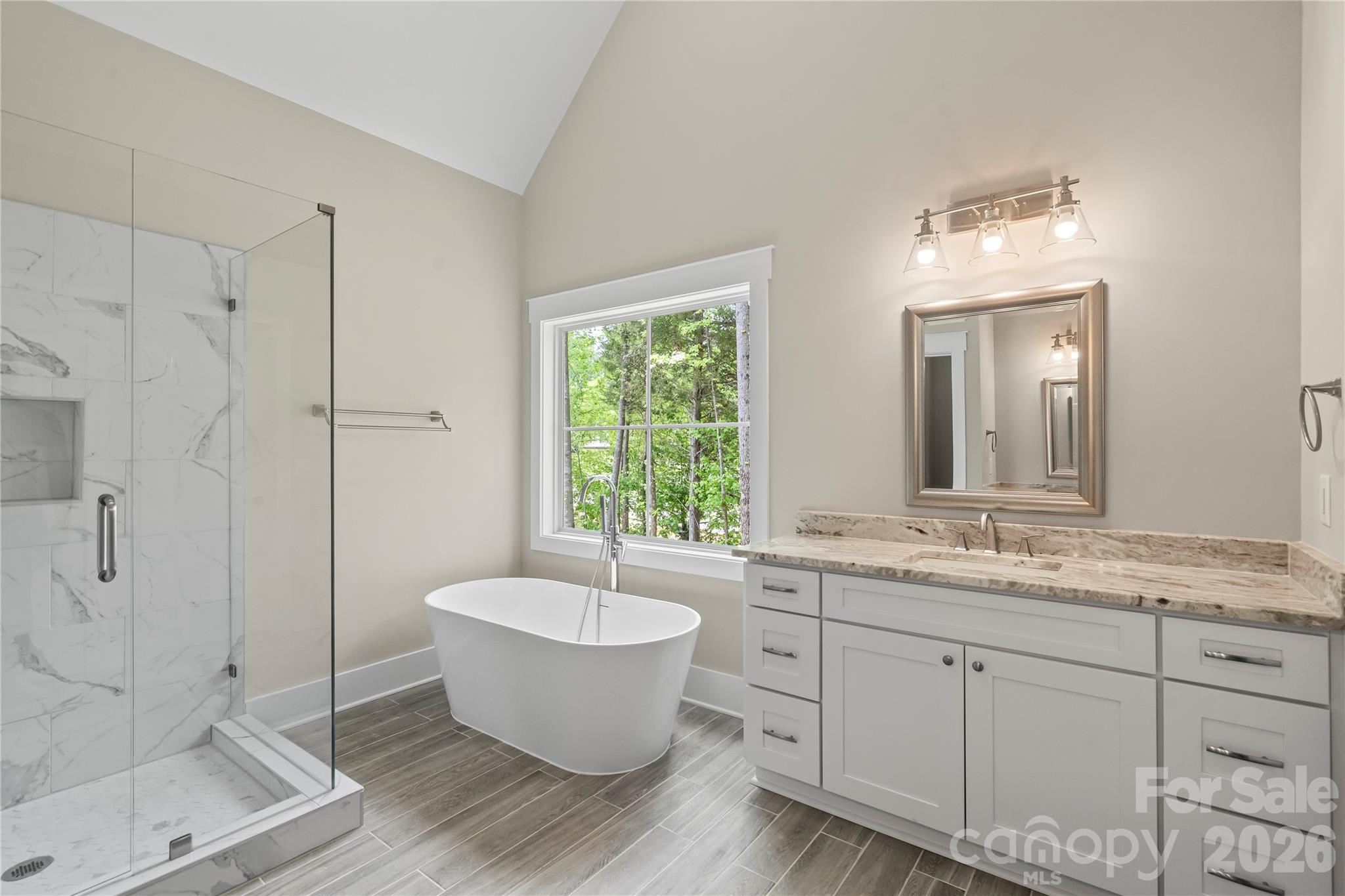 156 Clear Springs Road Mooresville, NC 28115 - Photo 15 of 28 a spacious bathroom with a double vanity sink a mirror and a bathtub