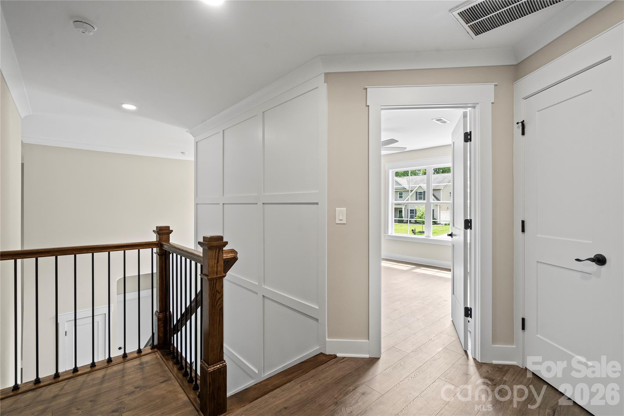 156 Clear Springs Road Mooresville, NC 28115 - Photo 16 of 28 a view of a hallway with wooden floor and a bathroom