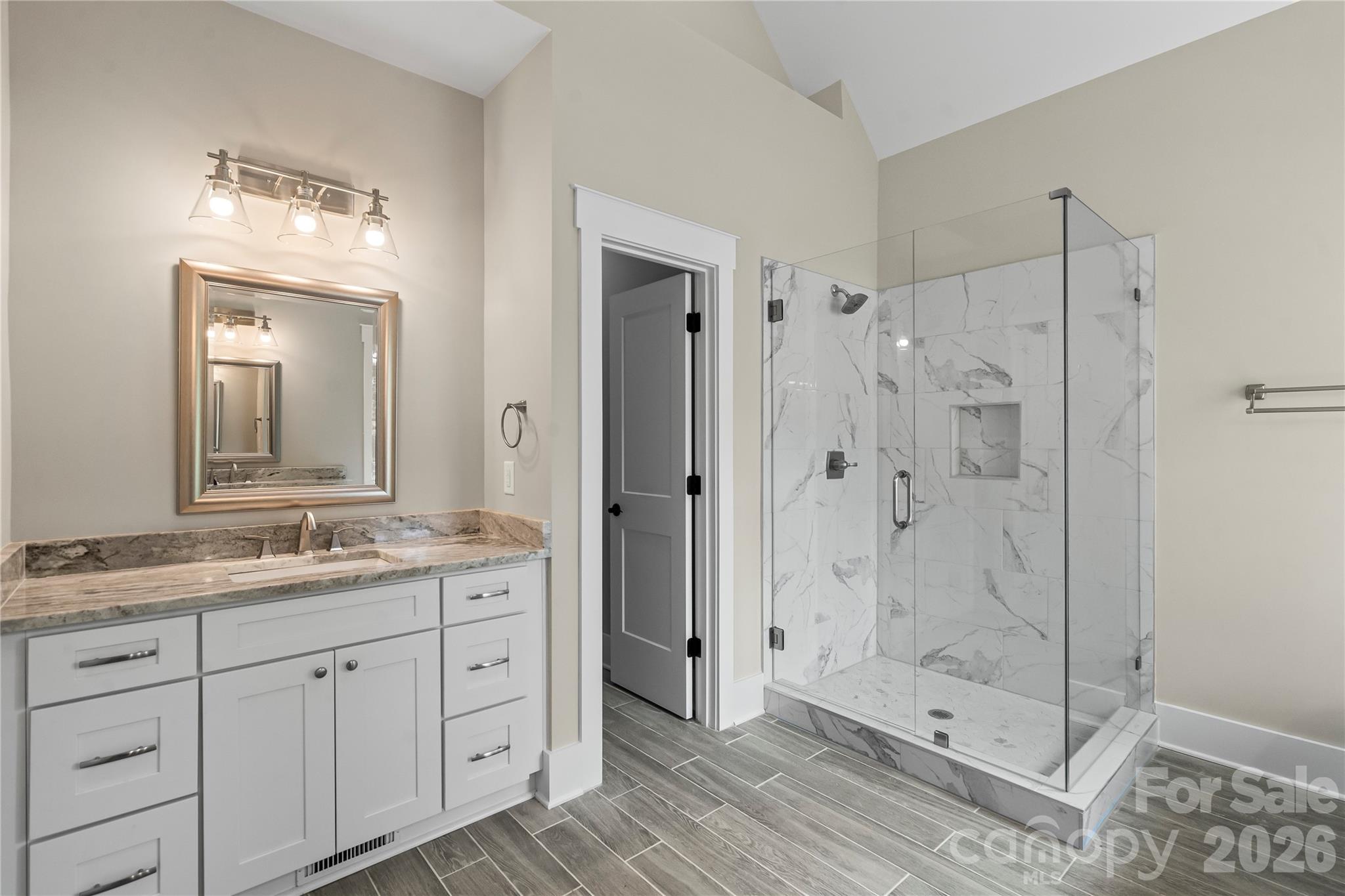 156 Clear Springs Road Mooresville, NC 28115 - Photo 16 of 28 a bathroom with a shower tub double vanity and a glass door shower