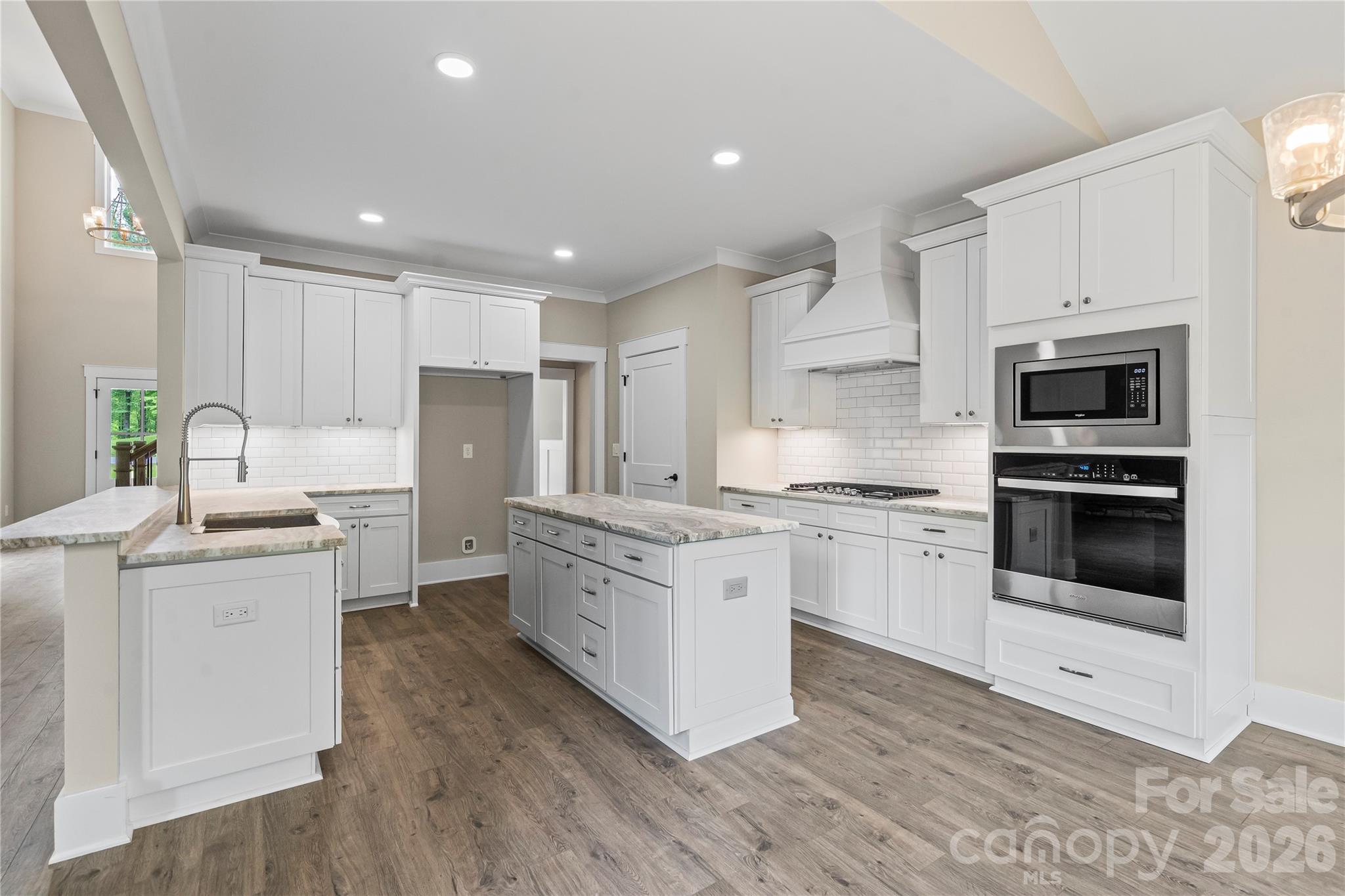 156 Clear Springs Road Mooresville, NC 28115 - Photo 8 of 28 a kitchen with granite countertop white cabinets and white appliances