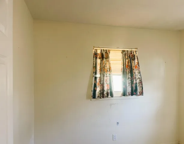 a front view of a house with a tree