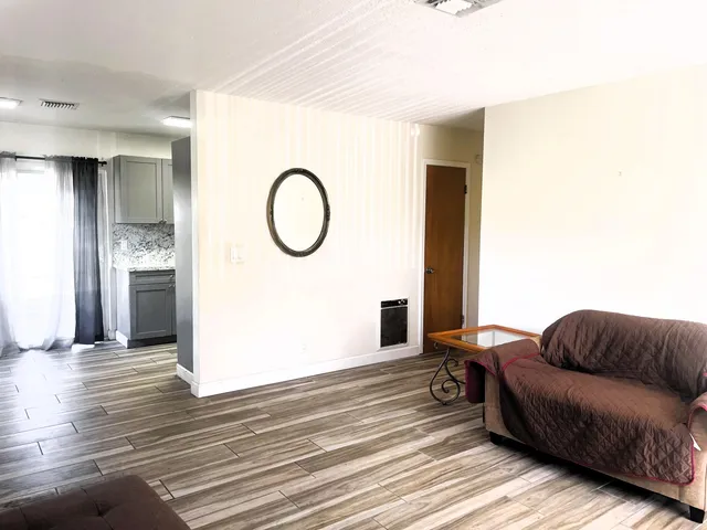 a living room with furniture and a floor to ceiling window