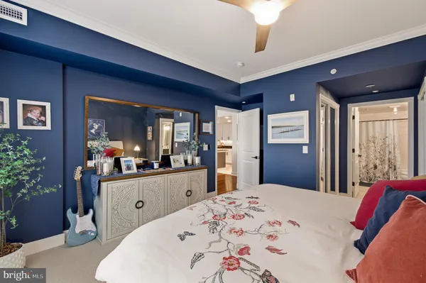 a bedroom with a bed and a large mirror with a potted plant