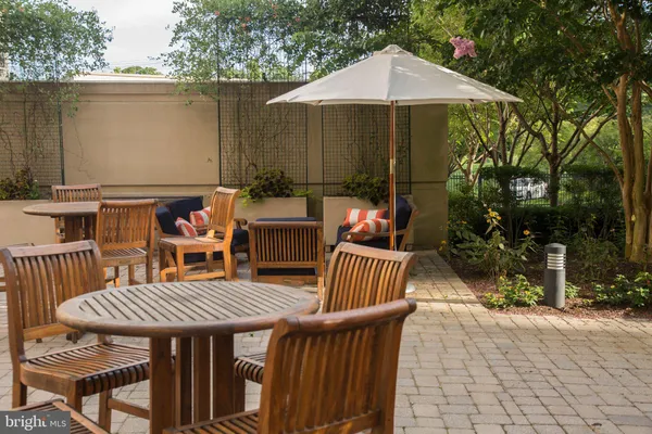 a view of a patio with table and chairs under an umbrella